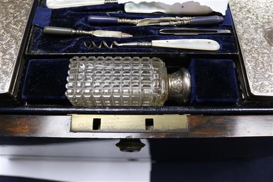 A Victorian brass mounted coromandel wood travelling toilet box with ten silver mounted toilet jars